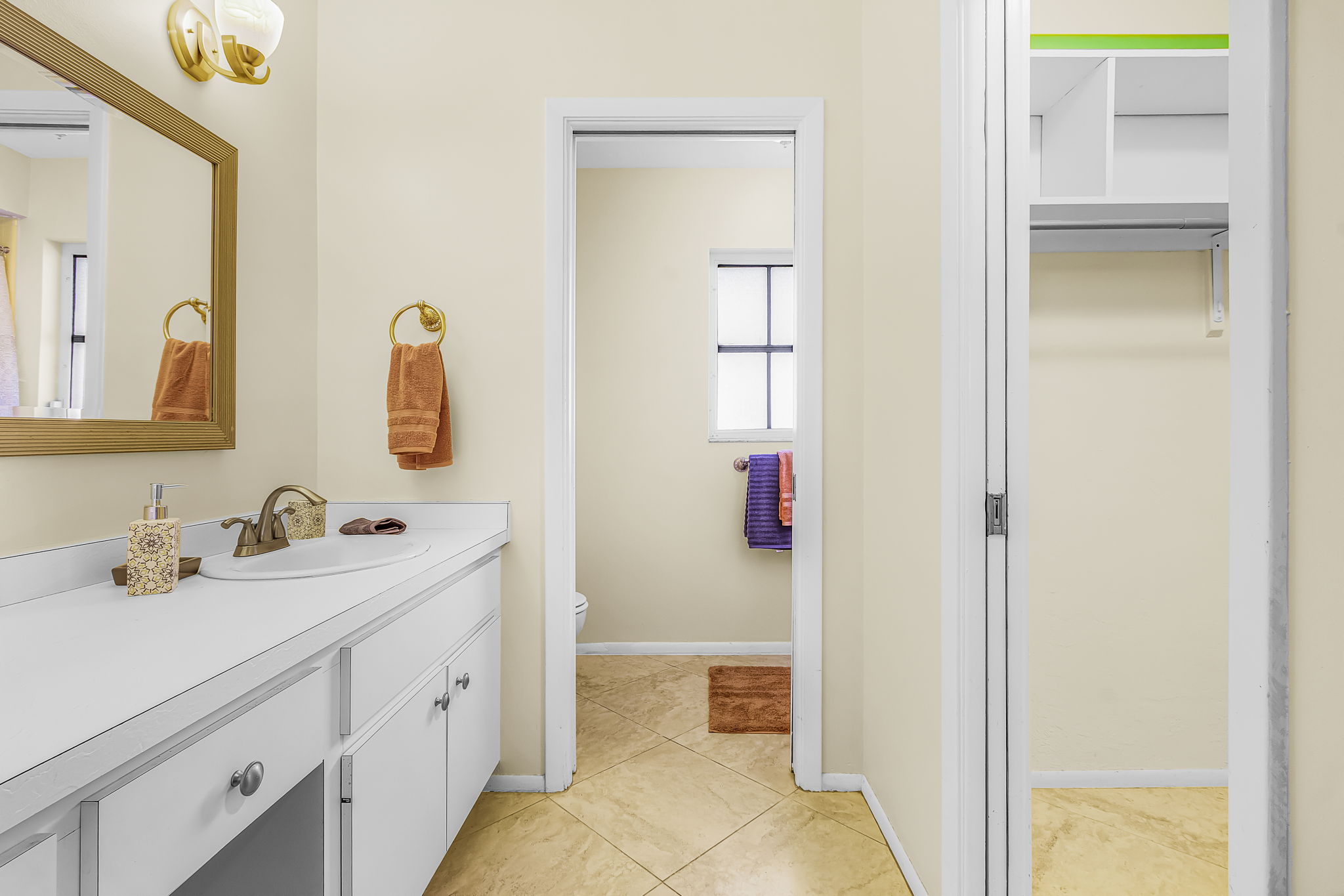Primary bathroom vanity and adjoining closet